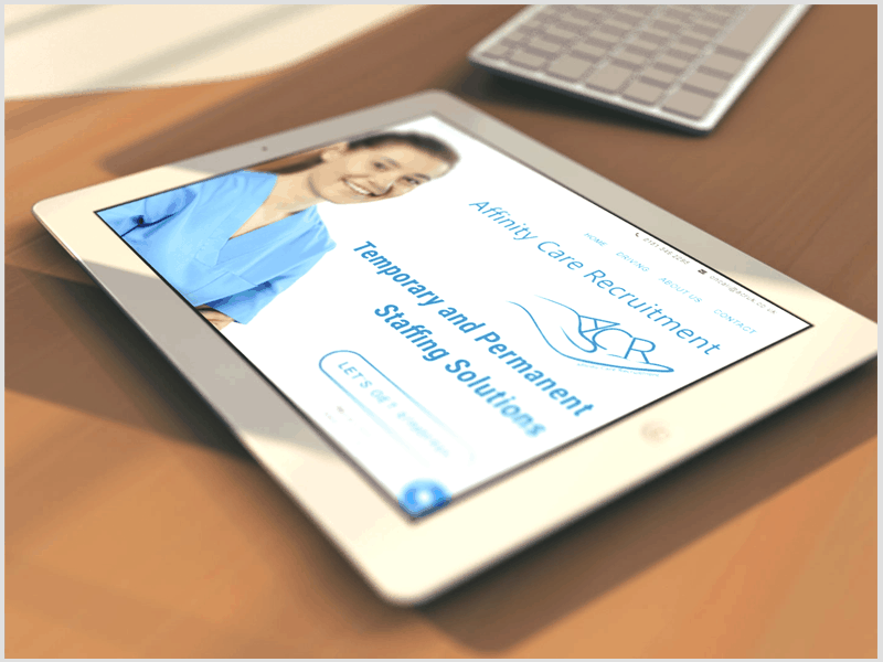 Web Design North Wales Our Work: EWD (Esthetig Web Design) Portfolio: Affinity Care Services website. Image shows a tablet on a wood effect table with a keyboard in the background. On the tablet is the Affinity Care Services website.